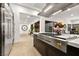 Bright kitchen with stainless steel appliances, custom island and seamless flow to other living areas at 803 Bolide St, Las Vegas, NV 89138