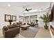 Bright living room with a ceiling fan, skylight, neutral decor, and modern furnishings at 803 Bolide St, Las Vegas, NV 89138