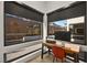 Bright office area featuring a modern desk setup, natural light, and views of the backyard at 803 Bolide St, Las Vegas, NV 89138