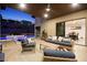 Inviting outdoor living space with comfortable seating, outdoor kitchen, and access to a sparkling pool at 803 Bolide St, Las Vegas, NV 89138