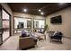 Stylish outdoor living area featuring contemporary furniture, ceiling fan, and views to interior spaces at 803 Bolide St, Las Vegas, NV 89138