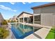 Modern home with a pristine pool, sleek patio, and well-manicured landscaping, perfect for outdoor living at 803 Bolide St, Las Vegas, NV 89138