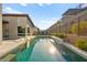 Stunning pool with a sleek design, featuring a waterfall, a sun shelf, and comfortable lounge seating at 803 Bolide St, Las Vegas, NV 89138