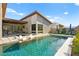 Serene backyard showcasing a modern pool, covered patio, and stylish lounge chairs for ultimate relaxation at 803 Bolide St, Las Vegas, NV 89138