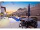 Backyard pool featuring stylish dining area and views of modern architecture and lush landscaping at 803 Bolide St, Las Vegas, NV 89138