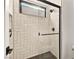 Modern shower with glass door, black trim, and white herringbone tile at 803 Bolide St, Las Vegas, NV 89138