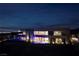 Hillside home exterior at night with multiple infinity pools, architectural lighting, and sweeping views of the Las Vegas strip at 811 Magnum Cliff Ct, Henderson, NV 89012