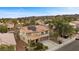 Aerial view of a home showcasing the tile roof, solar panels, landscaping, and the surrounding neighborhood at 820 Sandhill Sage St, Henderson, NV 89052