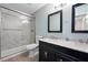 Bright bathroom with a glass-enclosed shower, double sink vanity with marble countertop, and modern fixtures at 820 Sandhill Sage St, Henderson, NV 89052