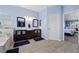 Bright bathroom with dual vanities, wood-look floors and separate tub and shower at 820 Sandhill Sage St, Henderson, NV 89052