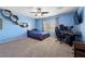Bedroom features carpet flooring, ample natural light, and modern decor with a ceiling fan at 820 Sandhill Sage St, Henderson, NV 89052