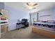 Bedroom featuring plush carpet, ceiling fan, and large window with a desk area at 820 Sandhill Sage St, Henderson, NV 89052