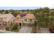 Charming two-story home with a well-manicured lawn, mature trees, and a welcoming entrance at 820 Sandhill Sage St, Henderson, NV 89052