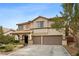 Two-story home with a well-manicured lawn, two-car garage, and beautiful desert landscaping at 820 Sandhill Sage St, Henderson, NV 89052