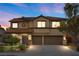 Charming two-story home featuring a tile roof, a well-manicured lawn, and an attached two-car garage at 820 Sandhill Sage St, Henderson, NV 89052