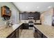 Bright kitchen with granite countertops, stainless steel appliances, and tiled flooring at 820 Sandhill Sage St, Henderson, NV 89052