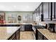Modern kitchen featuring granite countertops, stainless steel appliances, and dark wood cabinetry at 820 Sandhill Sage St, Henderson, NV 89052