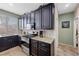 Well-lit kitchen featuring granite countertops, stainless steel appliances, and tiled backsplash at 820 Sandhill Sage St, Henderson, NV 89052
