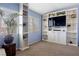 Bright living room with custom shelving, large windows, and carpet floors at 820 Sandhill Sage St, Henderson, NV 89052