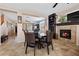 Open-concept living and dining area with fireplace and tiled flooring at 820 Sandhill Sage St, Henderson, NV 89052