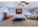 A beautiful main bedroom featuring a ceiling fan, carpet flooring, dresser and a lounge sofa at 820 Sandhill Sage St, Henderson, NV 89052