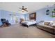 Spacious main bedroom with a ceiling fan, seating area, ensuite bath, and carpet floors at 820 Sandhill Sage St, Henderson, NV 89052