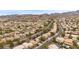 An aerial view of a neighborhood with homes, desert landscaping, and mountains in the distance at 820 Sandhill Sage St, Henderson, NV 89052