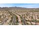 A high aerial shot displays a dense neighborhood surrounded by mountainous terrain under a clear sky at 820 Sandhill Sage St, Henderson, NV 89052