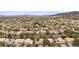 An aerial view of a neighborhood with various homes and desert landscaping in the background at 820 Sandhill Sage St, Henderson, NV 89052