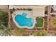 Aerial view of a backyard pool and patio area, featuring palm trees and landscaping at 820 Sandhill Sage St, Henderson, NV 89052