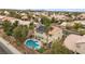Aerial view of a tan two-story home with a backyard pool and a desert landscape at 820 Sandhill Sage St, Henderson, NV 89052