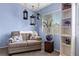 Bright sitting area in the main bedroom with a loveseat, shelving, and carpet floors at 820 Sandhill Sage St, Henderson, NV 89052