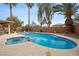 Inviting swimming pool and spa area with mature palm trees in a private backyard setting at 820 Sandhill Sage St, Henderson, NV 89052
