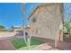 Spacious backyard featuring minimal landscaping, brick perimeter fencing, and covered patio space at 8754 Moon Crater Ave, Las Vegas, NV 89178