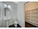 Powder room with a pedestal sink and a walk-in closet with white shelving providing storage at 8754 Moon Crater Ave, Las Vegas, NV 89178