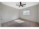 Neutral bedroom featuring ceiling fan, plush carpet, and a window letting in plenty of natural light at 8754 Moon Crater Ave, Las Vegas, NV 89178
