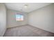 Well-lit bedroom featuring neutral paint, carpet flooring, and a window offering exterior views at 8754 Moon Crater Ave, Las Vegas, NV 89178