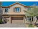 Two-story home with a three-car garage, well-maintained landscaping, and attractive architectural details at 8754 Moon Crater Ave, Las Vegas, NV 89178
