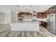 Spacious kitchen features a large island, stainless steel appliances, modern cabinets, and pendant lighting at 8754 Moon Crater Ave, Las Vegas, NV 89178