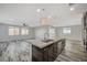 Open concept kitchen features a large island, stainless steel appliances, and ample counter space at 8754 Moon Crater Ave, Las Vegas, NV 89178