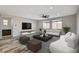 Bright living room with neutral tones, modern furniture, ceiling fan, and a view to the backyard at 8754 Moon Crater Ave, Las Vegas, NV 89178