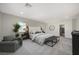 Relaxing main bedroom with a comfortable bed, sitting area, and closet entrance at 8754 Moon Crater Ave, Las Vegas, NV 89178
