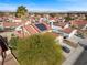 Aerial view showing red tile roofs, solar panels and mature landscaping in a suburban neighborhood at 8912 Dio Guardi Dr, Las Vegas, NV 89117