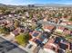 View of a neighborhood showcasing mature trees, well-maintained lawns, and residential homes at 8912 Dio Guardi Dr, Las Vegas, NV 89117