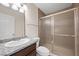 Bathroom featuring a granite vanity and framed glass shower enclosure at 8912 Dio Guardi Dr, Las Vegas, NV 89117