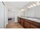Bathroom featuring double sinks, granite countertops, wood floors and closet at 8912 Dio Guardi Dr, Las Vegas, NV 89117