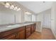 Bathroom showcasing double sinks, granite countertops, and bright lighting at 8912 Dio Guardi Dr, Las Vegas, NV 89117