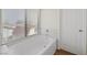 Bright bathroom featuring a modern bathtub with white trim and a window at 8912 Dio Guardi Dr, Las Vegas, NV 89117