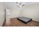 Bedroom features wood-look flooring, window with blinds and ceiling fan at 8912 Dio Guardi Dr, Las Vegas, NV 89117