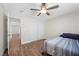 Comfortable bedroom features wood floors, closet, and a ceiling fan, offering a relaxing space at 8912 Dio Guardi Dr, Las Vegas, NV 89117